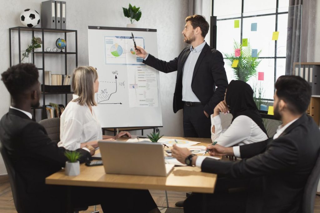 businessman making presentation on flip chart for colleagues